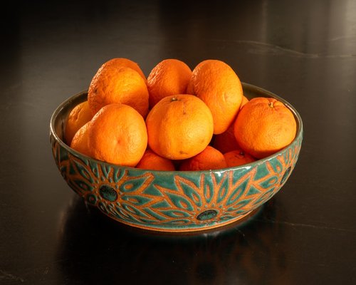 Ripe orange papaya chunks in a white bowl