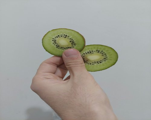 Green kiwi fruit slices showing seeds